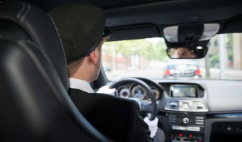 61867866 - rear view of a male chauffeur driving a car